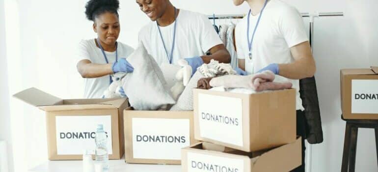 People packing boxes for donating - Ideas for leftover moving boxes