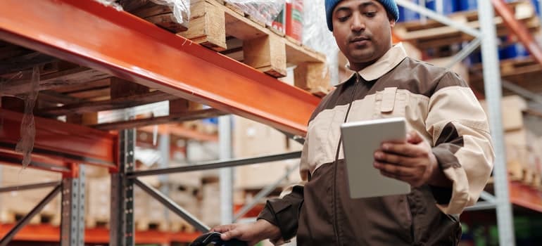 Man in the storage checking a list and thinking about benefits of using storage when home staging;