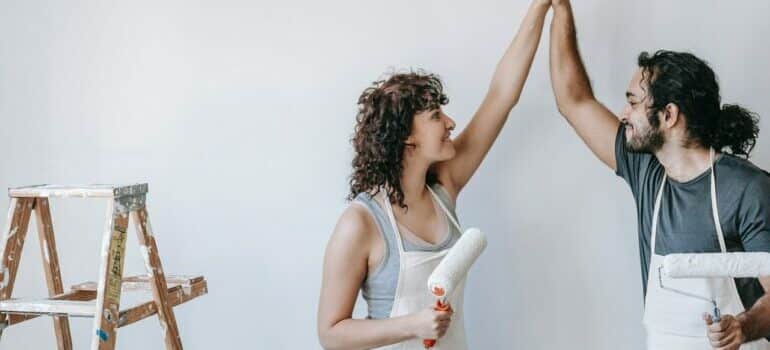 Couple painting the wall 