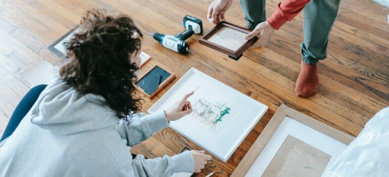 Couple hanging pictures on the wall - this is one of the easiest ways to update your Austin home 