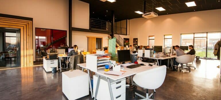 people sitting on chairs beside their desks in an office