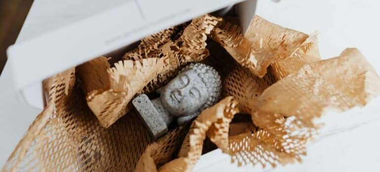Buddha statue carefully packed in box