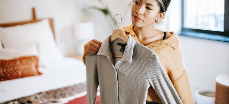 Women trying different clothes;