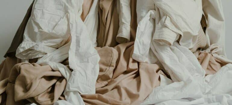 Pile of clothes -One of the best home decluttering tactics is to get rid of everything you didn't wear or use for a year