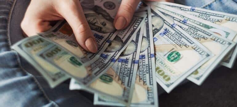 Several dollar bills inside a person's hand