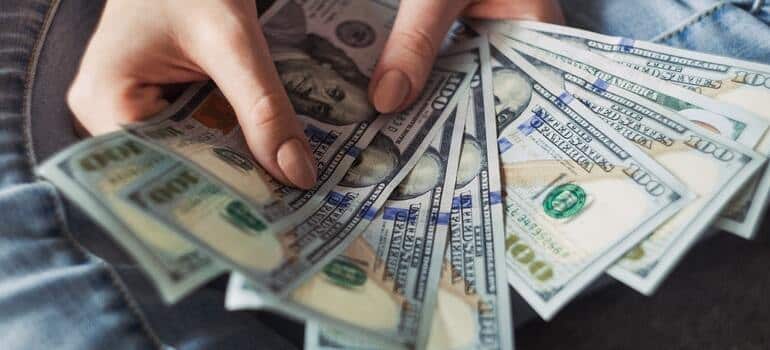 A person holding a lot of money