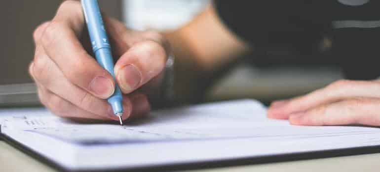 A person writing down a list