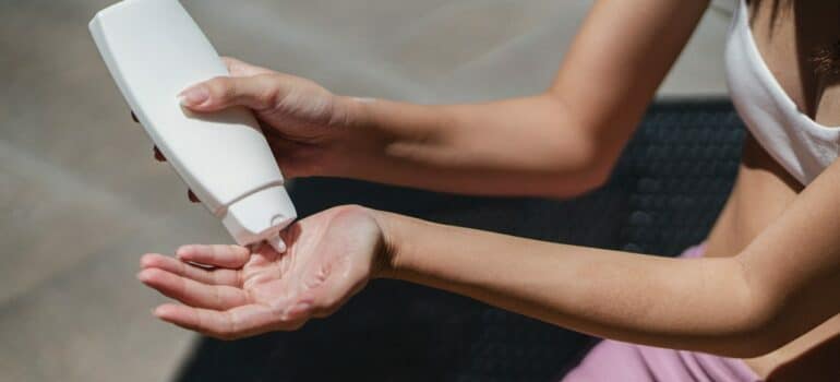 woman putting spf before moving in the summer heat