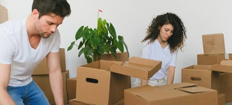 Two people packing things in the boxes