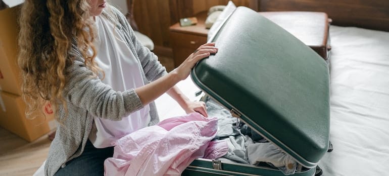 Women packing a suitcase.