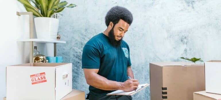 Professional mover making a list of boxes