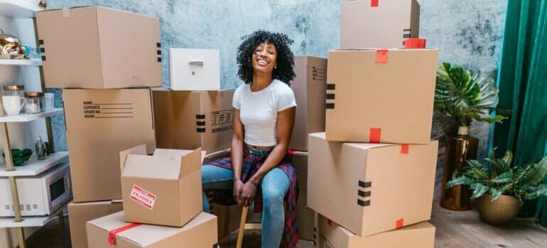 Girl siting behind boxes and getting ready for fall move-in day 
