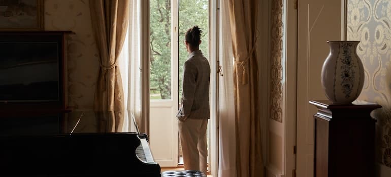 Man in white lookin through the window