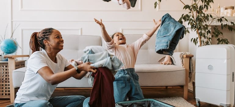 Mother and daufgter having fun while packing.