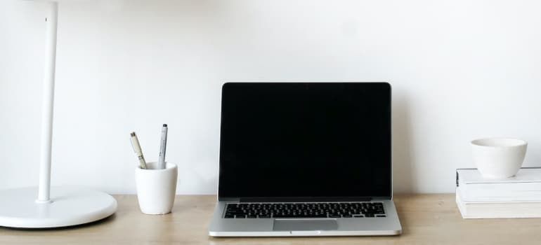 organized table with laptop and pencils