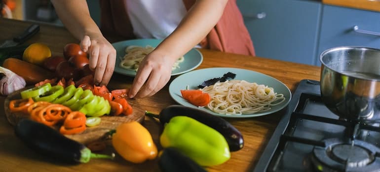 Hands of a Person Preparing Spaghetti. 