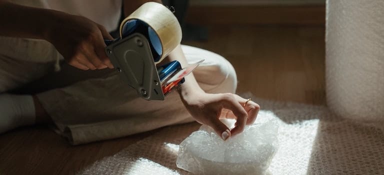 wrapping an item into bubble bag