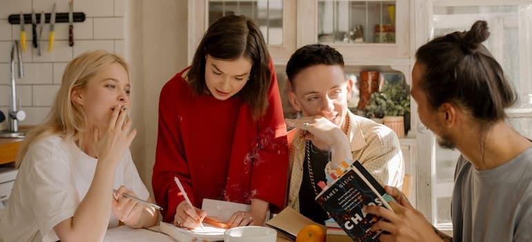 Young people around the table learning - students renting apartments in Westlake TX.