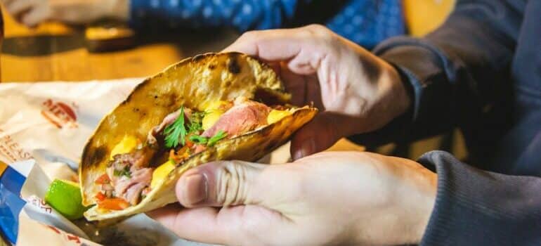Person eating tacos is one of the moving tips from Austin locals that will help you fit in