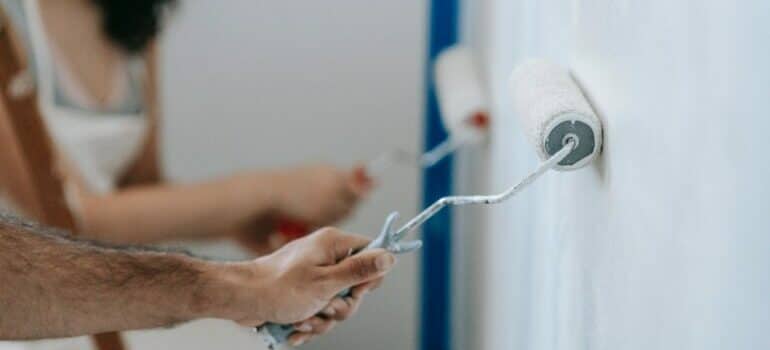 Two people painting the walls 