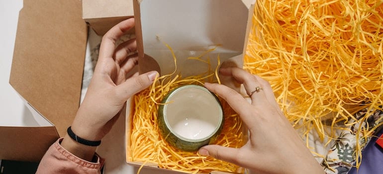 Anonymous man preparing cups for shipment
