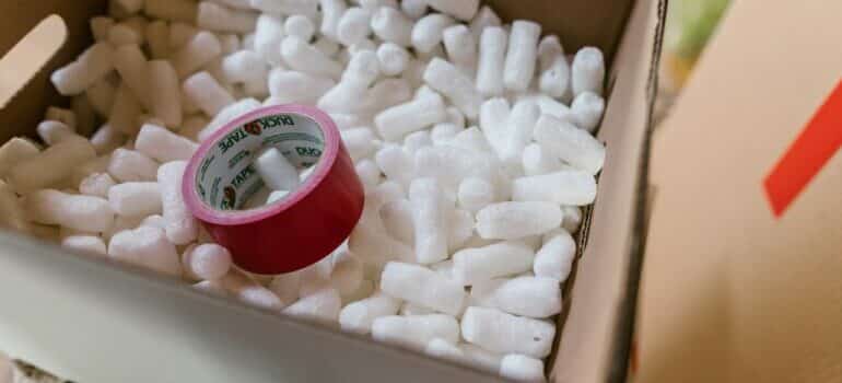 Card box, tape and peanuts can be used to make Halloween costumes from leftover moving supplies