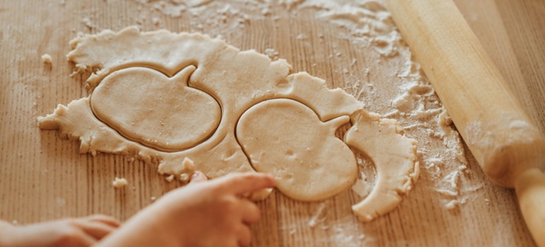 A woman making pumpkins cookies