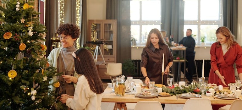 Family adding to Christmas curb appeal by decorating the tree and preparing dinner