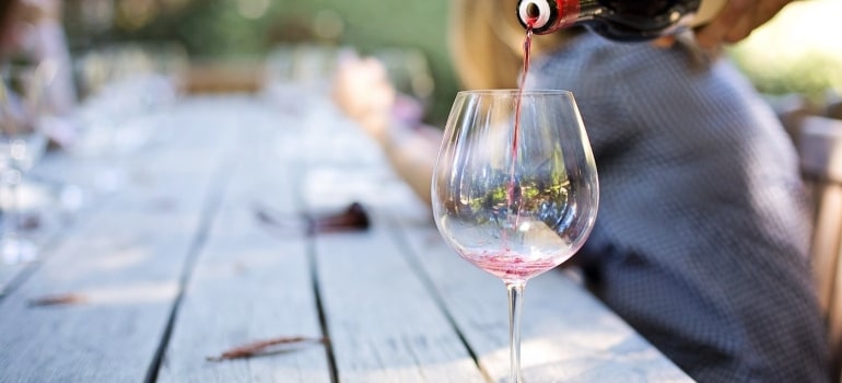 A bottle of wine and a glass