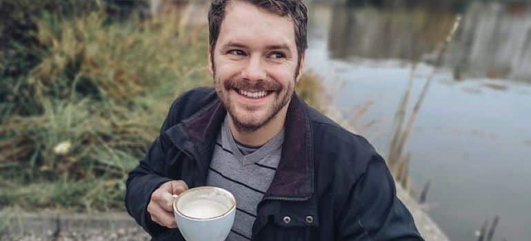 A man is happy after moving out of state after a divorce.