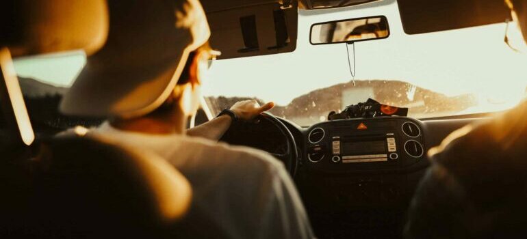 Man driving a car in the sun and navigating Austin's traffic
