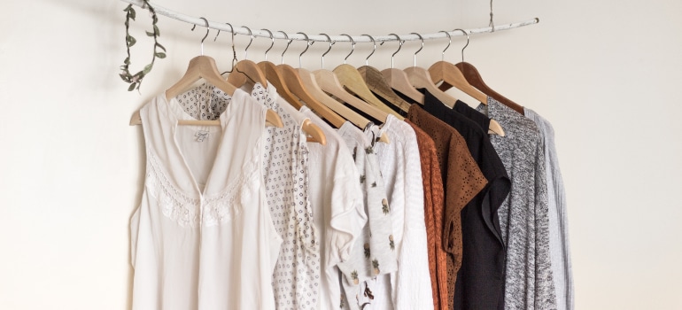 A pile of shirts on a shirt rack